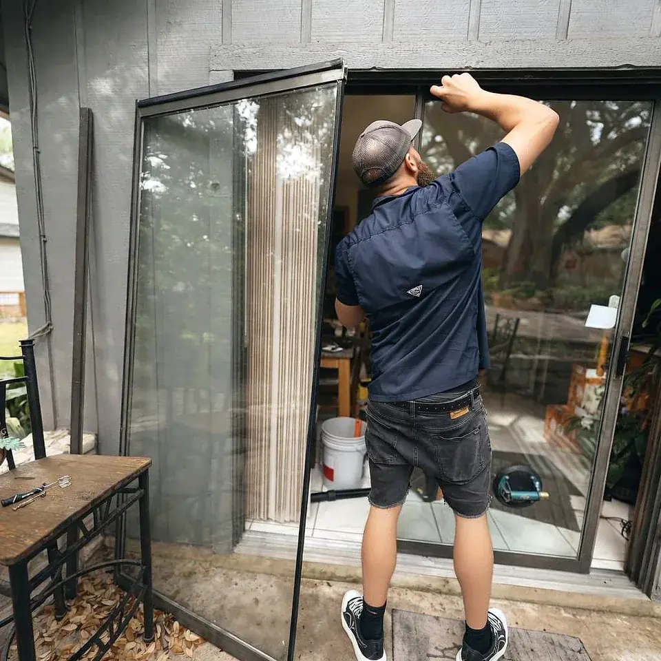 Handyman installing wall cabinets inside residential home
