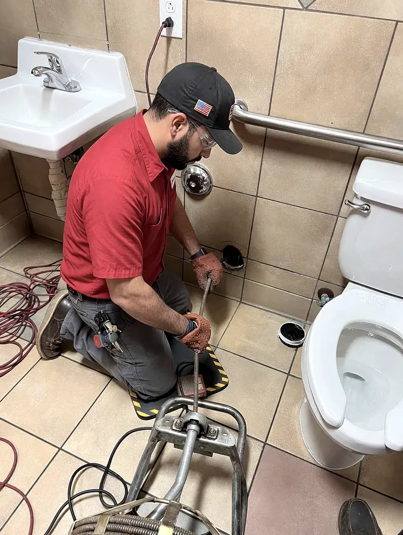 HomeHeroes plumber clearing a clogged drain in Charlotte